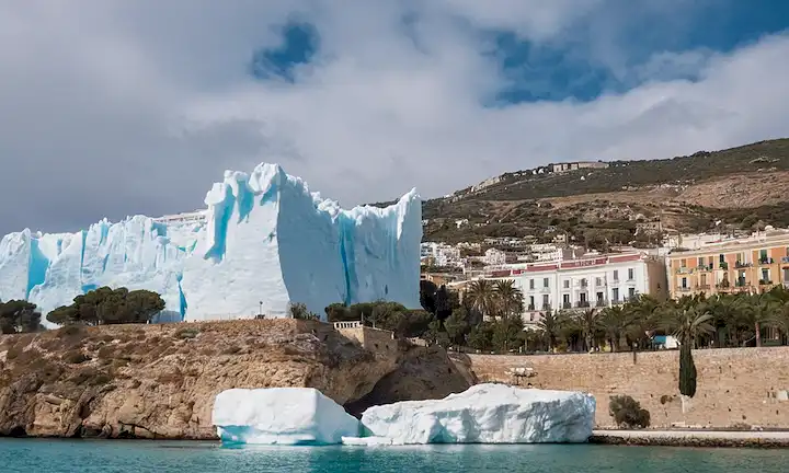 Persona de pie frente a un edificio, apuntando hacia arriba mientras que los edificios que los rodean se envolven envueltos por icebergs con el nombre de la ciudad Málaga y símbolo del cambio climático (ícono de temperatura establecido para derretir nieve) en el fondo. Esto podría interpretarse como una representación metafórica para superar los esfuerzos a nivel de la ciudad contra el cambio climático, acompañada de dramáticas señales visuales que representan a Iceberg de toneladas del mar cerca de Málaga, España.